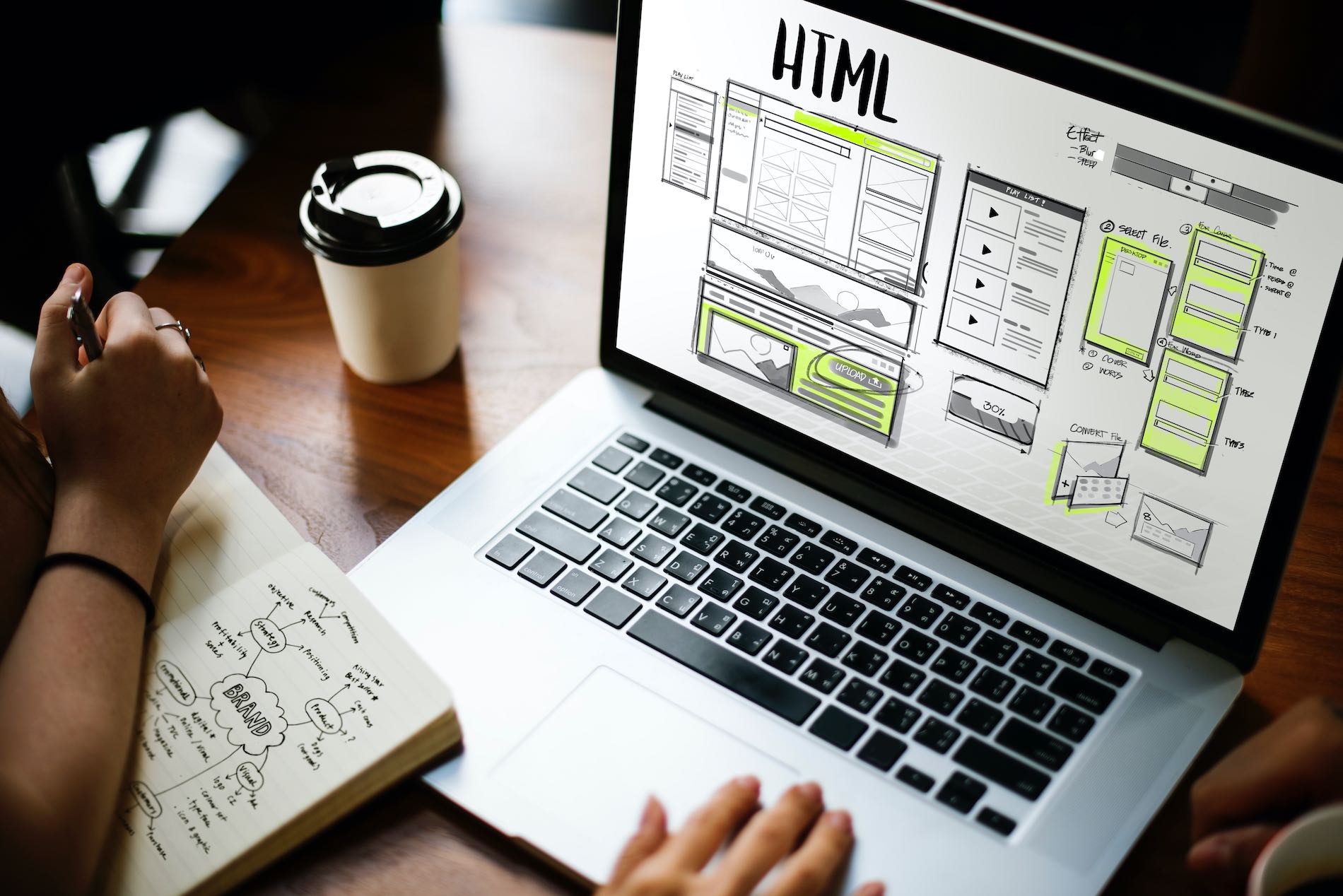 Website Redesign - Designer working on laptop with HTML