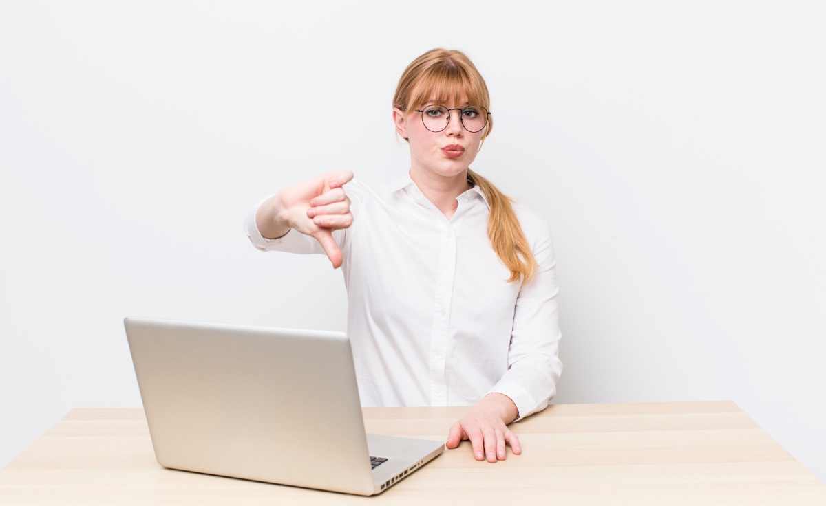 Blog 101 Woman Making A Thumbs Down Gesture To Show Common Web Design Mistakes To Avoid