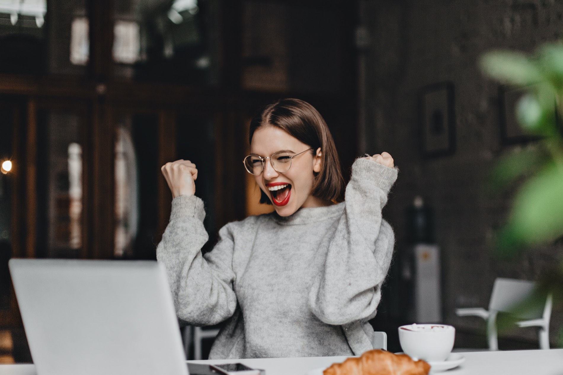 Woman excited by reading about hot to get your website noticed