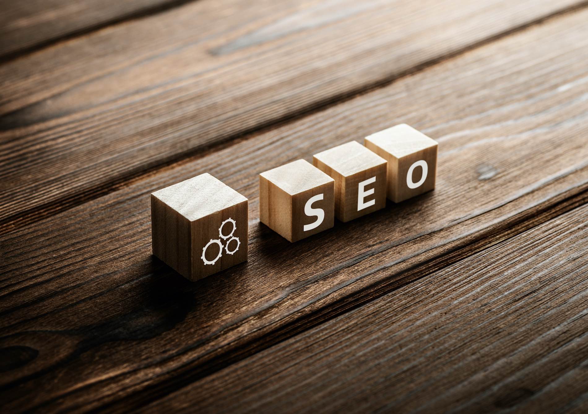 Small wooden blocks on a wood surface that spell out “SEO” for search engine optimization and SEO terms for beginners