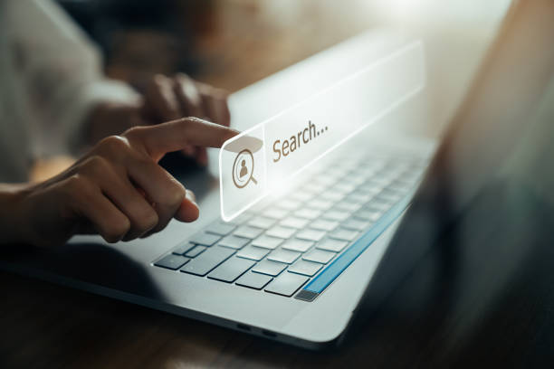 Man Pointing At Superimposed Search Bar Above Laptop Keyboard