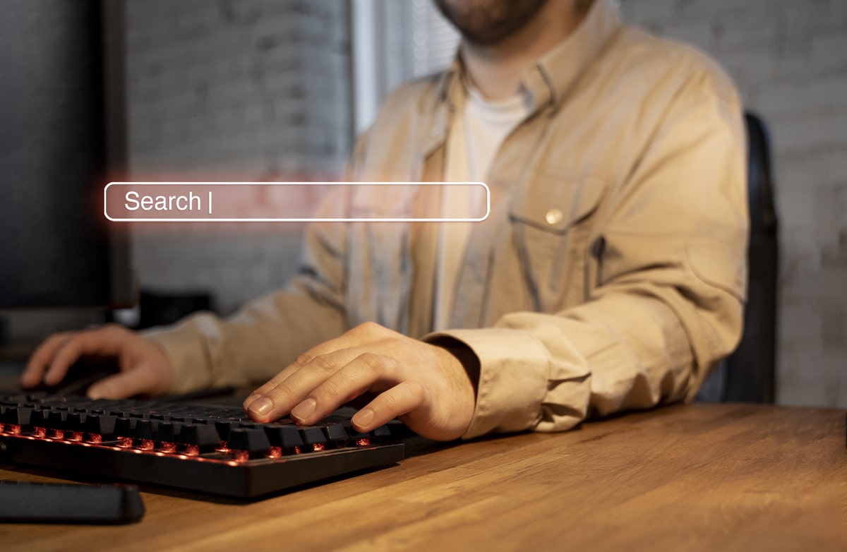 How To Choose Keywords For Seo 4 Person Typing On A Keyboard With A Digital Search Bar Overlay, Representing Seo Search Intent