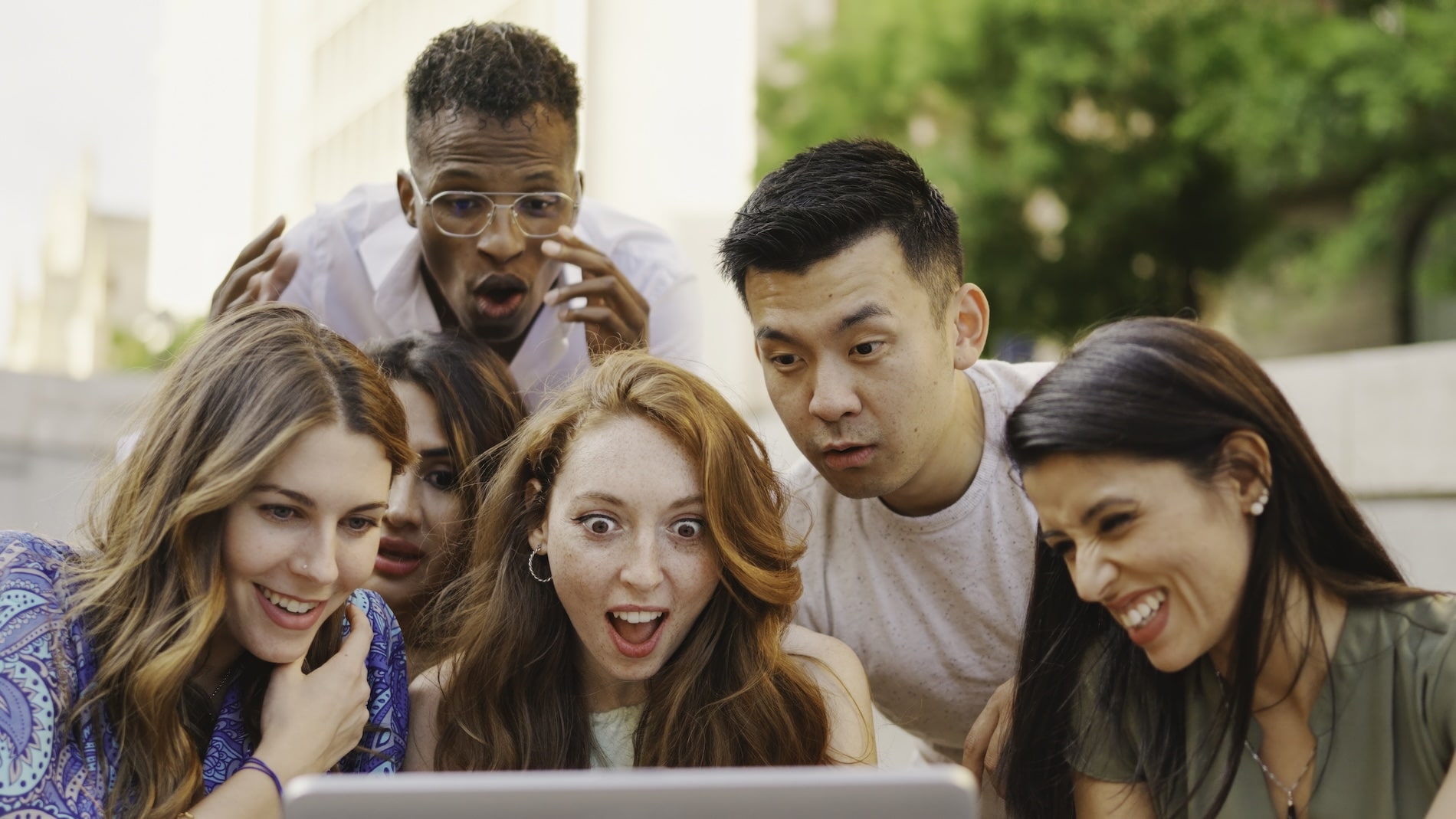 Homepage Design Best Practices: How To Pass The 5-Second Test 5 Diverse Group Of People Reacting To A Website Design On A Laptop Screen.